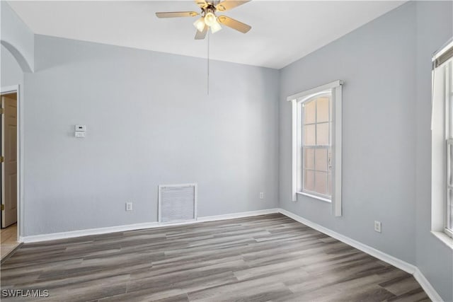 1023 SE 6th St, Cape Coral, FL 33990 - spare room featuring a ceiling fan, arched walkways, and wood finished floors