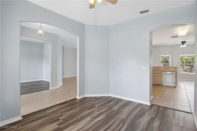 1023 SE 6th St, Cape Coral, FL 33990 - empty room featuring ceiling fan, wood finished floors, and arched walkways