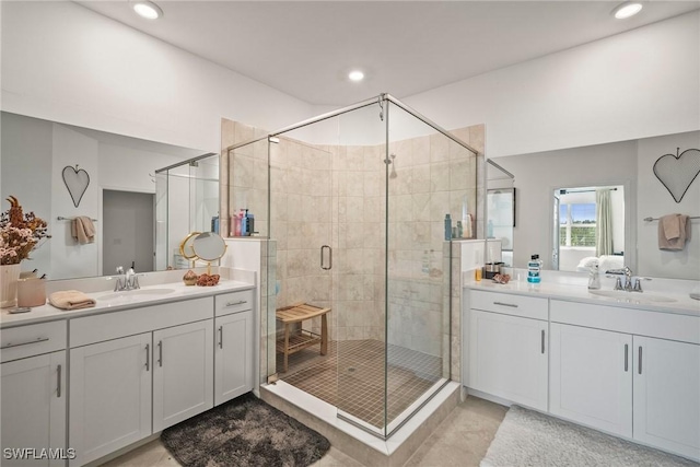 15887 Grassland Ln Unit 4622, Punta Gorda, FL 33982 - bathroom featuring two vanities, tile patterned flooring, a shower stall, and recessed lighting