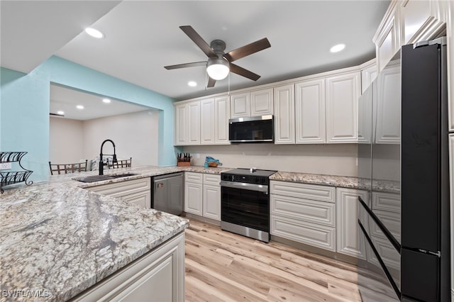 4938 Vincennes St Unit 3, Cape Coral, FL 33904 - kitchen featuring appliances with stainless steel finishes, a ceiling fan, light wood finished floors, recessed lighting, and light stone counters