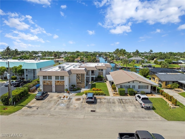 4938 Vincennes St Unit 3, Cape Coral, FL 33904 - view of front facade with uncovered parking and a water view