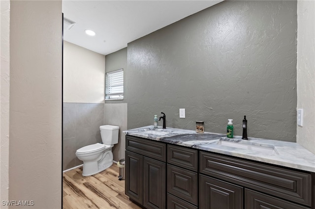4938 Vincennes St Unit 3, Cape Coral, FL 33904 - bathroom with wood finished floors, double vanity, and a textured wall