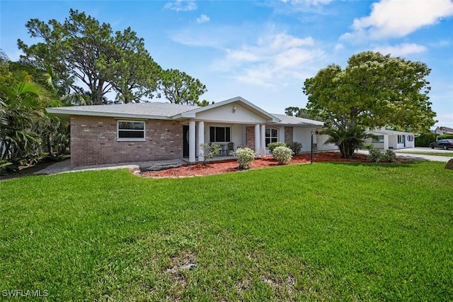 165 4th St, Bonita Springs, FL 34134 - single story home featuring a porch, brick siding, and a front lawn