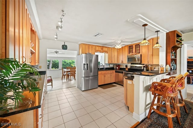 165 4th St, Bonita Springs, FL 34134 - kitchen featuring stainless steel appliances, a ceiling fan, a peninsula, and light tile patterned floors