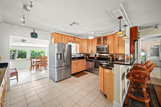 165 4th St, Bonita Springs, FL 34134 - kitchen with appliances with stainless steel finishes, a ceiling fan, a peninsula, and light tile patterned floors