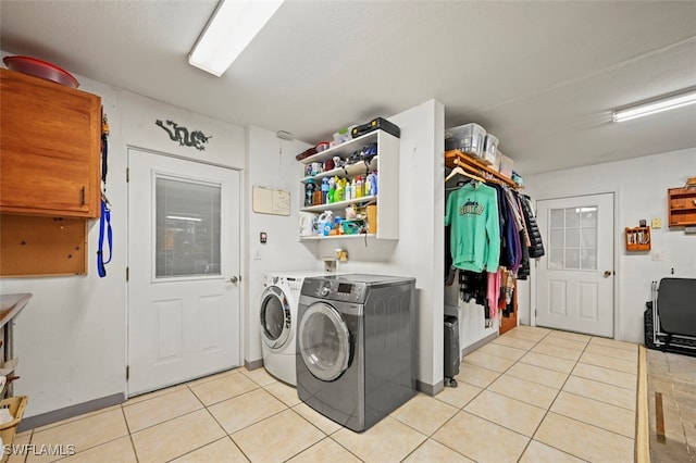 165 4th St, Bonita Springs, FL 34134 - laundry area with washer and clothes dryer and light tile patterned floors