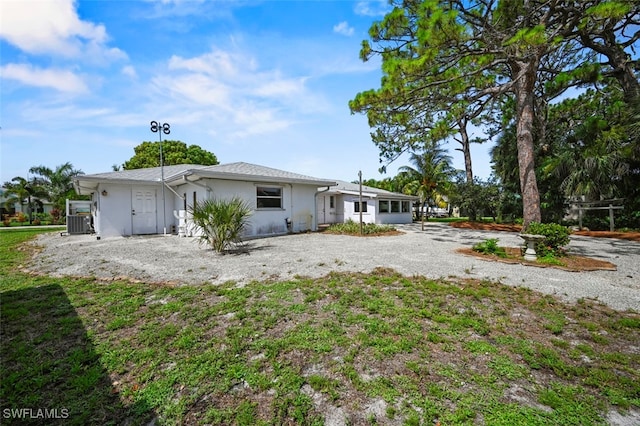 165 4th St, Bonita Springs, FL 34134 - rear view of house with stucco siding