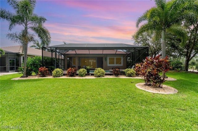 20551 Long Pond Rd, North Fort Myers, FL 33917 - back of house at dusk featuring a yard and a lanai