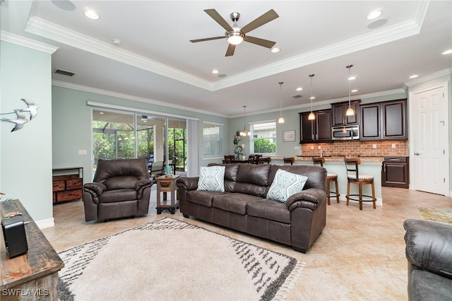 20551 Long Pond Rd, North Fort Myers, FL 33917 - living room featuring ceiling fan and ornamental molding