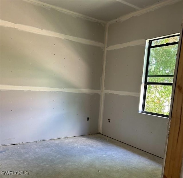 3481 24th Ave NE, Naples, FL 34120 - spare room featuring healthy amount of natural light and unfinished concrete flooring