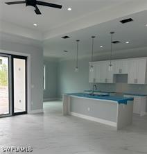 3481 24th Ave NE, Naples, FL 34120 - kitchen featuring ceiling fan, white cabinetry, a center island, and recessed lighting