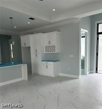 3481 24th Ave NE, Naples, FL 34120 - unfurnished living room featuring baseboards and light marble finish flooring