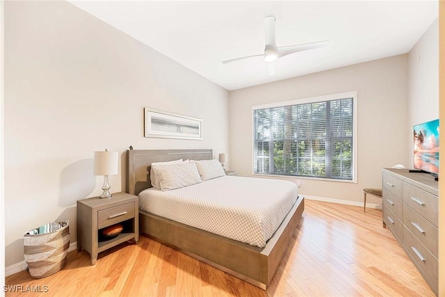 24400 Reserve Ct Unit 103, Bonita Springs, FL 34134 - bedroom with light wood finished floors and ceiling fan
