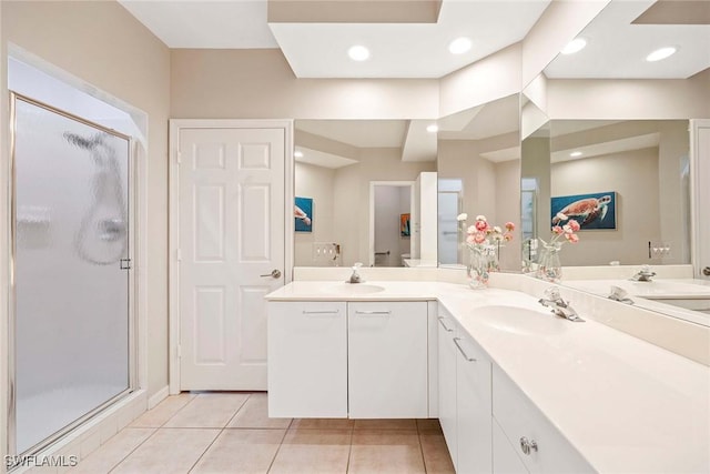24400 Reserve Ct Unit 103, Bonita Springs, FL 34134 - bathroom featuring double vanity, a stall shower, and tile patterned floors