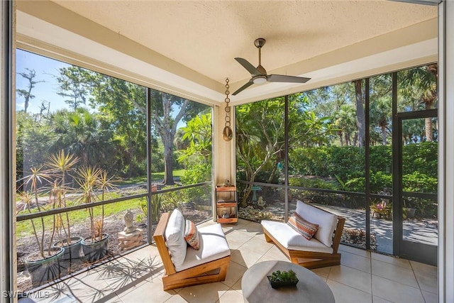 24400 Reserve Ct Unit 103, Bonita Springs, FL 34134 - sunroom / solarium with a ceiling fan, tile patterned flooring, an outdoor hangout area, view of wooded area, and a textured ceiling
