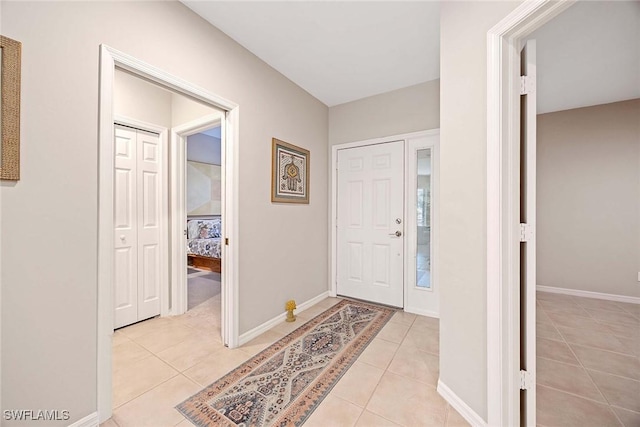 24400 Reserve Ct Unit 103, Bonita Springs, FL 34134 - entryway featuring light tile patterned floors and baseboards