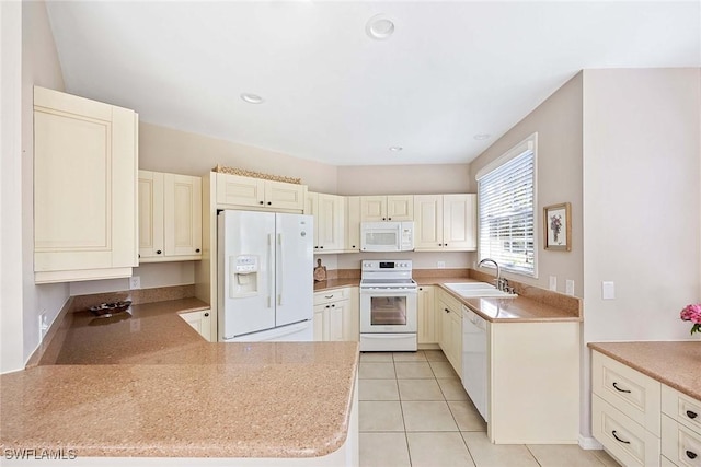 24400 Reserve Ct Unit 103, Bonita Springs, FL 34134 - kitchen featuring white appliances, light tile patterned floors, recessed lighting, and a peninsula