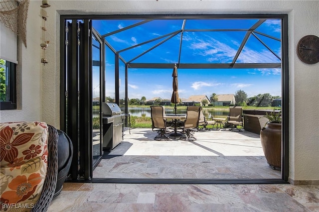 14274 Arrow Point Ct, Estero, FL 33928 - view of patio / terrace featuring outdoor dining space, a water view, a lanai, and area for grilling