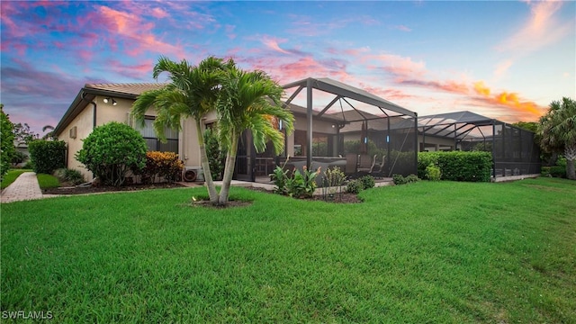 14274 Arrow Point Ct, Estero, FL 33928 - rear view of property featuring a yard, stucco siding, and glass enclosure