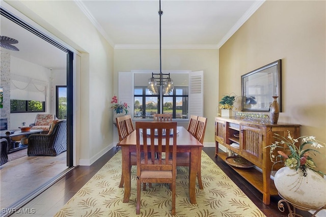 14274 Arrow Point Ct, Estero, FL 33928 - dining space featuring a chandelier, dark wood-style floors, and crown molding