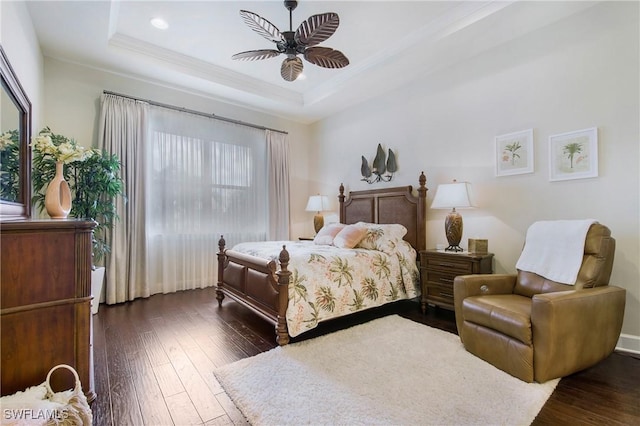 14274 Arrow Point Ct, Estero, FL 33928 - bedroom featuring ornamental molding, a tray ceiling, dark wood-style flooring, and a ceiling fan