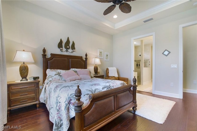 14274 Arrow Point Ct, Estero, FL 33928 - bedroom featuring dark wood-style floors, a tray ceiling, ornamental molding, recessed lighting, and connected bathroom