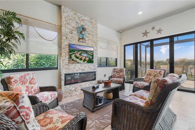 14274 Arrow Point Ct, Estero, FL 33928 - living area featuring a stone fireplace and recessed lighting