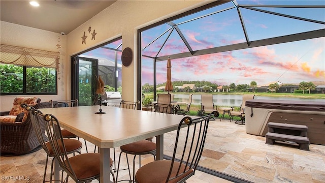 14274 Arrow Point Ct, Estero, FL 33928 - patio terrace at dusk with a hot tub, a patio, a water view, a grill, and glass enclosure