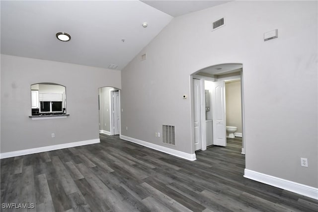 4154 Castilla Cir Unit 204, Fort Myers, FL 33916 - unfurnished room with arched walkways, dark wood-type flooring, and high vaulted ceiling