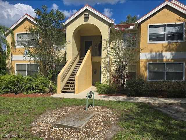 12551 Equestrian Cir Unit 704, Fort Myers, FL 33907 - view of front of house featuring stucco siding and stairway