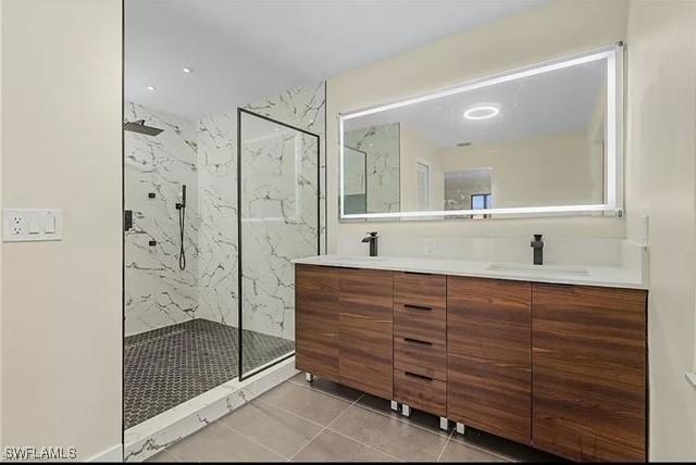 813 SW 52nd St, Cape Coral, FL 33914 - full bath featuring tile patterned flooring, a marble finish shower, and double vanity