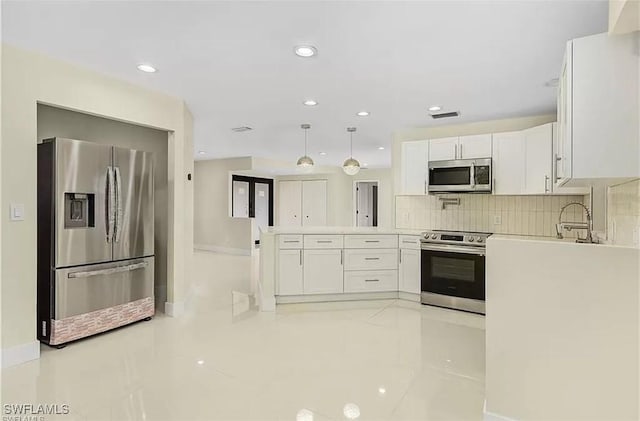 813 SW 52nd St, Cape Coral, FL 33914 - kitchen featuring stainless steel appliances, white cabinetry, a peninsula, light countertops, and recessed lighting