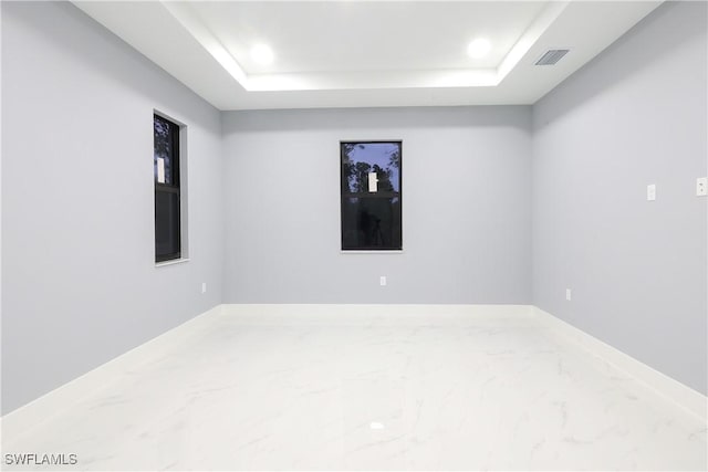 2714 2nd St SW, Lehigh Acres, FL 33976 - spare room with marble finish floors, a raised ceiling, and recessed lighting