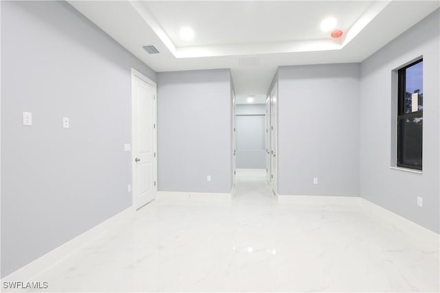 2714 2nd St SW, Lehigh Acres, FL 33976 - empty room with marble finish floors and a tray ceiling