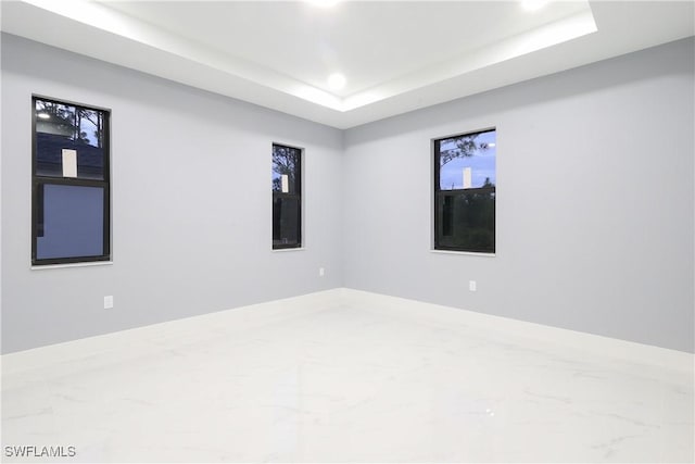 2714 2nd St SW, Lehigh Acres, FL 33976 - unfurnished room with recessed lighting, marble finish floors, and a raised ceiling