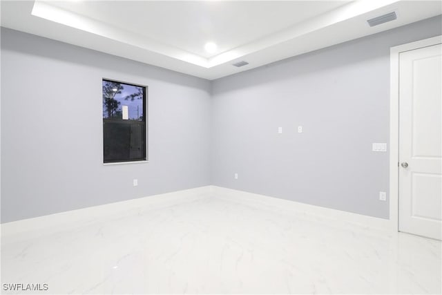 2714 2nd St SW, Lehigh Acres, FL 33976 - spare room with marble tiled floors, recessed lighting, and a tray ceiling