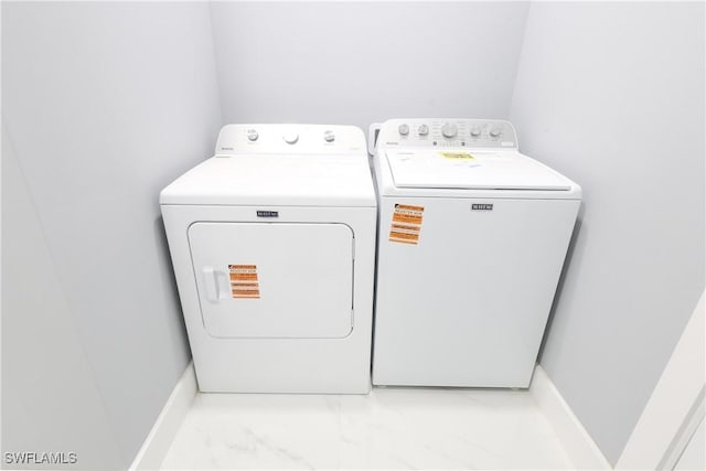 2714 2nd St SW, Lehigh Acres, FL 33976 - laundry room with washer and dryer and light marble finish floors