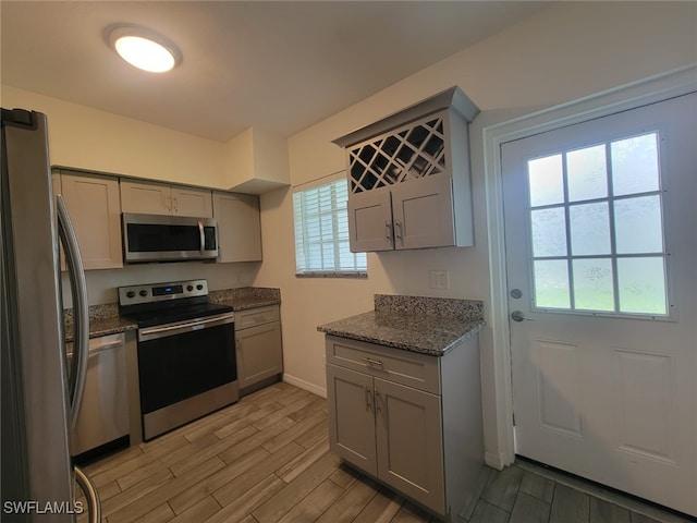 8313 Bernwood Cove Loop Unit 1211, Fort Myers, FL 33966 - kitchen featuring stainless steel appliances, gray cabinetry, plenty of natural light, and wood tiled floors