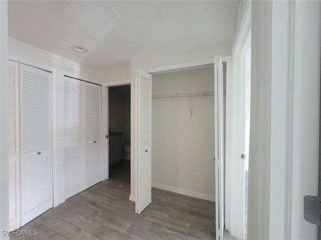 8313 Bernwood Cove Loop Unit 1211, Fort Myers, FL 33966 - unfurnished bedroom with multiple closets and wood finished floors