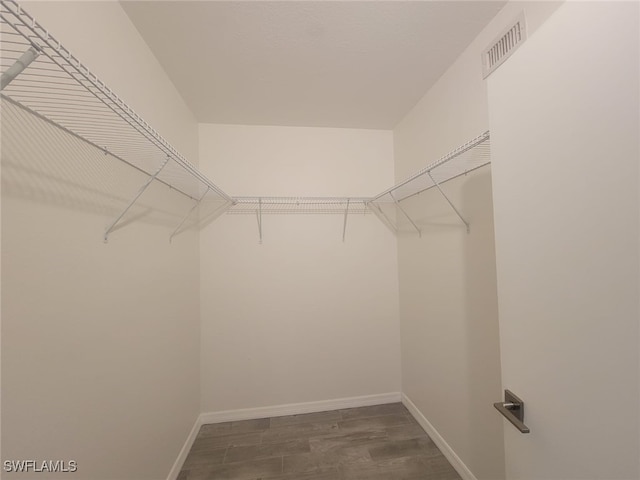 8313 Bernwood Cove Loop Unit 1211, Fort Myers, FL 33966 - spacious closet with dark wood-style flooring