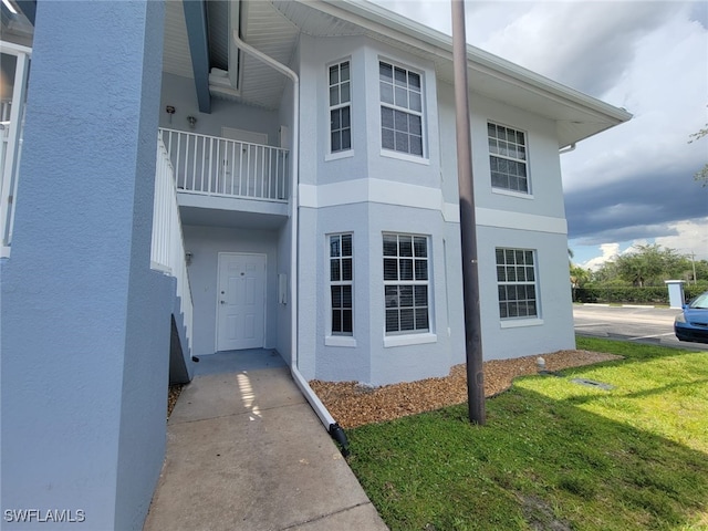 8313 Bernwood Cove Loop Unit 1211, Fort Myers, FL 33966 - view of home's exterior featuring stucco siding and a lawn