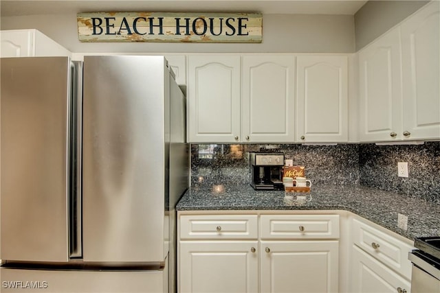 841 SW 47th Ter Unit 206, Cape Coral, FL 33914 - kitchen featuring appliances with stainless steel finishes, decorative backsplash, white cabinetry, and dark stone countertops