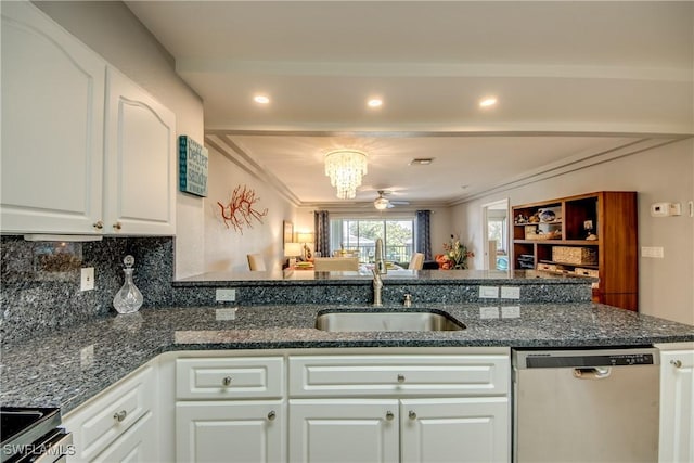 841 SW 47th Ter Unit 206, Cape Coral, FL 33914 - kitchen with appliances with stainless steel finishes, white cabinetry, decorative backsplash, a chandelier, and dark stone counters