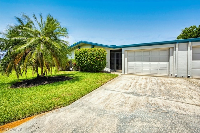 5554 Hamlet Ln, Fort Myers, FL 33919 - view of front of house featuring a garage, concrete driveway, and a front yard