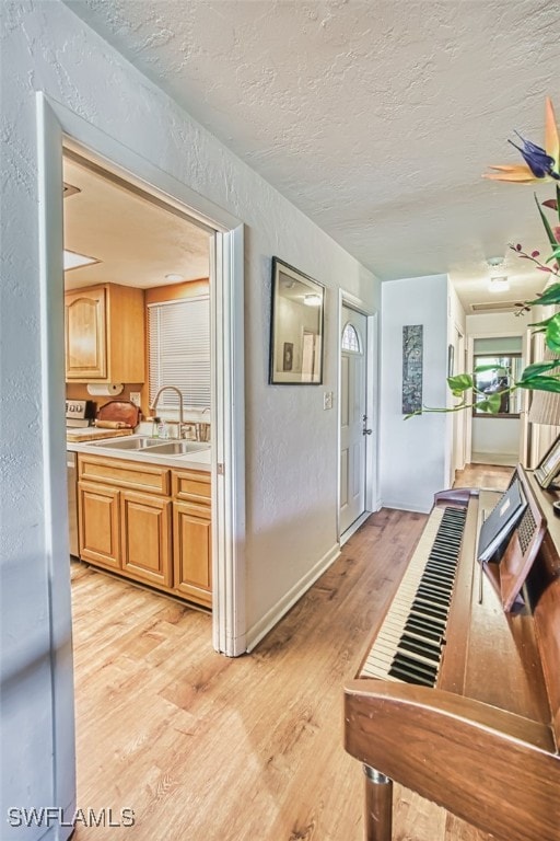 5554 Hamlet Ln, Fort Myers, FL 33919 - corridor with a textured ceiling, light wood-type flooring, and a textured wall