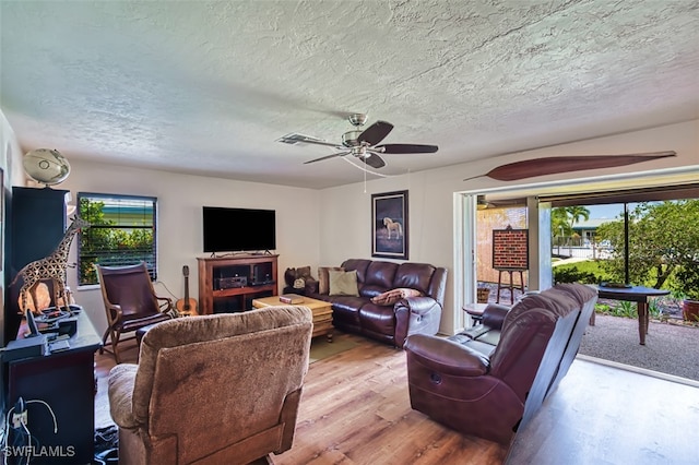 5554 Hamlet Ln, Fort Myers, FL 33919 - living area with wood finished floors, a textured ceiling, and a ceiling fan