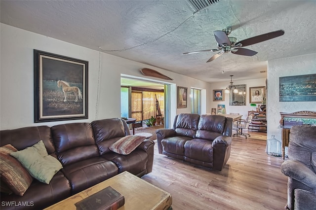 5554 Hamlet Ln, Fort Myers, FL 33919 - living room with wood finished floors, a textured ceiling, a chandelier, and ceiling fan