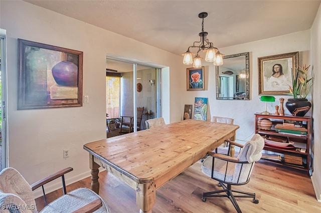 5554 Hamlet Ln, Fort Myers, FL 33919 - dining space with light wood-type flooring and a chandelier
