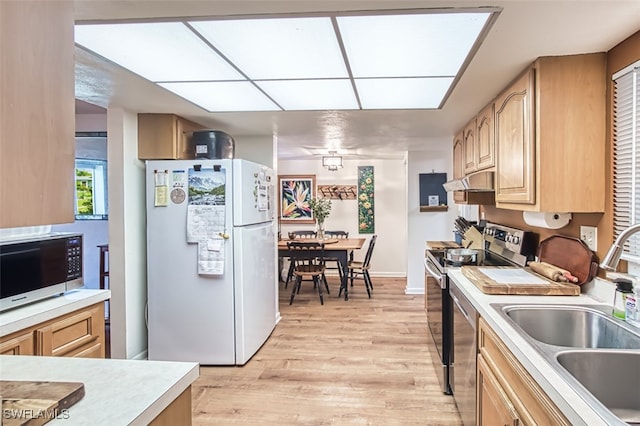 5554 Hamlet Ln, Fort Myers, FL 33919 - kitchen featuring appliances with stainless steel finishes, light brown cabinetry, light countertops, light wood-type flooring, and under cabinet range hood