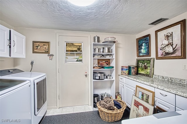 5554 Hamlet Ln, Fort Myers, FL 33919 - washroom with cabinet space, washing machine and dryer, light tile patterned floors, and a textured ceiling